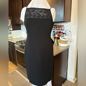 Black cocktail dress with beading on sheer top part of dress.